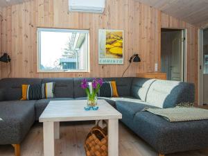 a living room with a couch and a table at 5 person holiday home in Knebel in Knebel