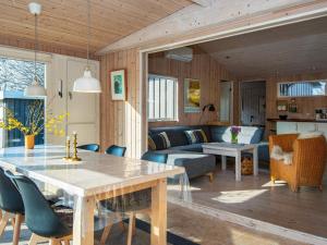 a kitchen and living room with a table and chairs at 5 person holiday home in Knebel in Knebel