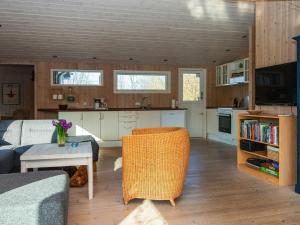 a living room with a couch and a table at 5 person holiday home in Knebel in Knebel