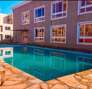 a house and a swimming pool in front of a building at Champions Chill Suite in Eldoret