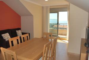 a dining room with a table and a view of the ocean at Apartamentos Marsil in Montalvo