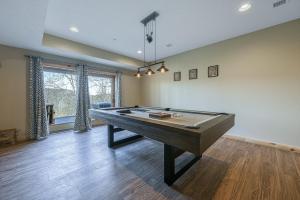 a large room with a pool table in it at Curb-Free Chalet in McHenry