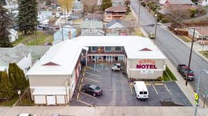 Siesta Motel Colfax WA في Colfax: اطلالة علوية على موتيل به سيارات متوقفة في موقف للسيارات
