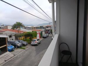 a balcony with cars parked in a parking lot at Pinares de Santa monica 6HB in Nueva San Salvador