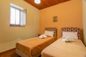 a room with two beds with stuffed animals on them at Morfeas Guesthouse in Papigko