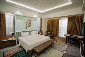 Ένα ή περισσότερα κρεβάτια σε δωμάτιο στο Luwansa Hotel and Convention Center Manado