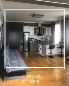 a living room with a couch and a kitchen at Doors in Kutaisi