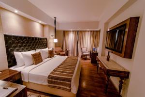 Ein Bett oder Betten in einem Zimmer der Unterkunft Sarovar Portico Jaipur
