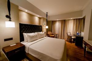 Ein Bett oder Betten in einem Zimmer der Unterkunft Sarovar Portico Jaipur