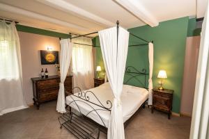 a bedroom with a canopy bed and two dressers at Lange in Priocca +48 photos