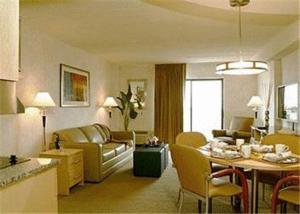 a living room with a kitchen and a dining room at Boardwalk Resorts- La Sammana in Brigantine