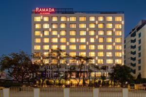 a building with a sign on top of it at Ramada by Wyndham Jaipur North in Jaipur