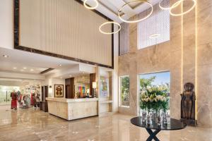 a lobby of a store with a vase of flowers on a table at Ramada by Wyndham Jaipur North in Jaipur +103 photos