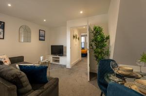a living room with a couch and a tv at 5 MINS To CENTRAL - LONG STAY OFFER - FREE PARKING in Strood
