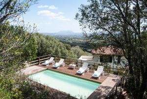 a swimming pool with a deck and lounge chairs at Villa Aurora in Olbia