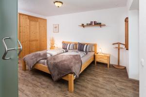 a bedroom with a bed with two pillows at Villa am First in Oberstdorf