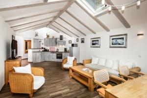 a living room with a couch and chairs and a table at Villa am First in Oberstdorf