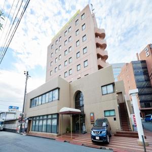 un bâtiment avec une voiture garée devant lui dans l'établissement Select Inn Hamamatsu Ekimae, à Hamamatsu