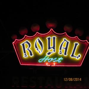 a neon sign that says rolleilossost at Royal Host Motel in Las Cruces
