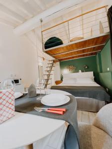 a bedroom with a bed and a table with plates on it at Casa Mysa - Apartment in Costa di Mezzate