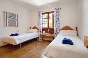 a bedroom with two beds and a window at Puerto Chico W in Playa Blanca +17 photos