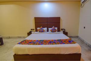 a bedroom with a large bed in a room at FabHotel Red Rose in Amingaon