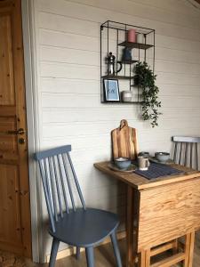 a table and a chair next to a wall at Ramberg Gjestegård in Ramberg