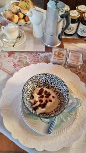 a bowl of coffee on a plate on a table at Corte degli OstiNati in Variano