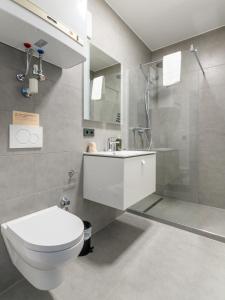 a bathroom with a toilet and a sink and a shower at limehome Villach Gerbergasse in Villach
