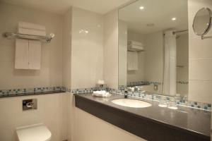a bathroom with a sink and a mirror at Holiday Inn London Bloomsbury, an IHG Hotel in London
