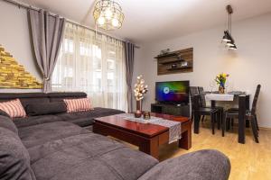 a living room with a couch and a table at 1BD flat with a Garage - 5 mins to the city centre in Plovdiv