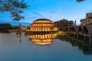 a building sitting on top of a body of water at Wyndham Grand Vedana Ninh Binh Resort in Ninh Binh