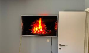 a fireplace with a tv on top of it at Privé-kamer centrum Oostende met eigen badkamer/wc in Ostend