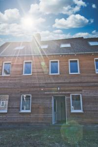 a brick house with the sun shining on it at Ferienhaus Eulenspiegel in Clausthal-Zellerfeld