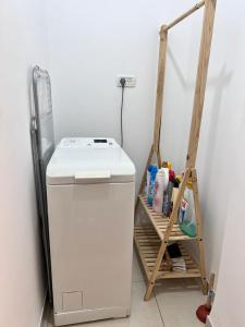 a small refrigerator in a corner with a shelf at Hadar Rest & Relax in Kefar H̱ittim