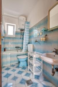 a blue tiled bathroom with a toilet and a sink at Apartmani Olga in Petrovac na Moru +46 photos