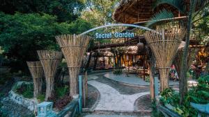 a group of bamboo trees in front of a store at Mua Caves Ecolodge (Hang Mua) in Ninh Binh