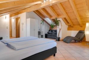 a large bedroom with a bed and a couch at Ferienwohnung mit Bergblick in Unterammergau +39 photos
