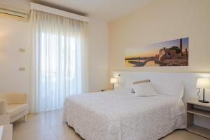 Кровать или кровати в номере Hotel Jonio