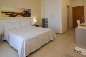 Кровать или кровати в номере Hotel Jonio