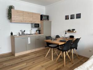 a kitchen with a table and chairs in a room at Wolfgangsee Seeblickplatzl 119 in Strobl