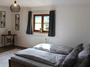 a bedroom with a bed and a window at Landhaus Glücksmoment in Rottau