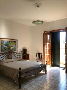 a bedroom with a bed and a sliding glass door at L'Arca in Talsano