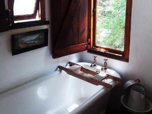 a bathroom with a sink and a bath tub at The Barn, McGregor in McGregor