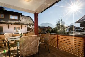 a patio with a table and chairs on a balcony at Zweistapfenweg 9a in Oberstdorf
