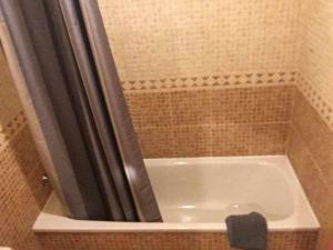 a bathroom with a bath tub with a shower at Pretty Apartament in Barcelona