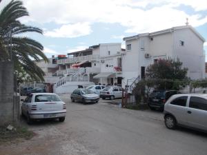 a group of cars parked in front of buildings at Apartments Idolga in Bar