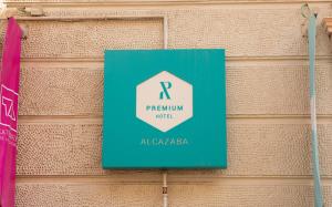 a green sign on a blue wall at Alcazaba Premium Hotel in Málaga