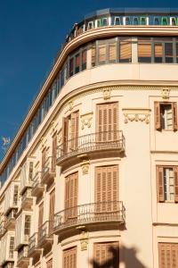 a building with two windows and a balcony at Alcazaba Premium Hotel in Málaga