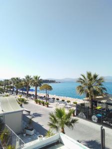 a view of a beach with palm trees and the ocean at Diamanto Rooms in Eretria